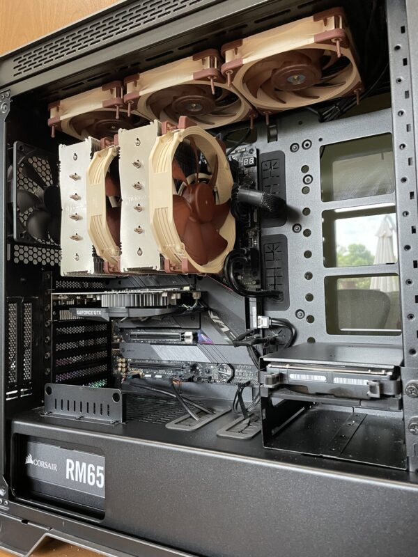 Inside of my computer, showing the massive CPU cooler and multiple Noctua fans on both the cooler and across the top of the case